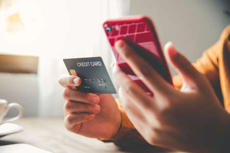 Women's hands holding a credit card and work on laptop Online payment for online shopping