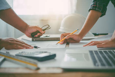 engineer working in office with blueprints, inspection in workplace for architectural plan,...