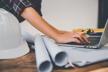 engineer working in office with blueprints, inspection in workplace for architectural plan, construction project ,Business constructionの写真素材