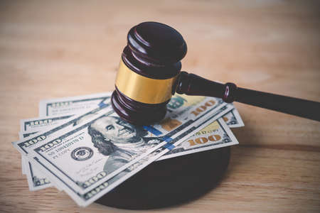 Law and justice concept. Judge hammer with the dollar placed - concept of judgment and justice. About fraud tax finesの写真素材