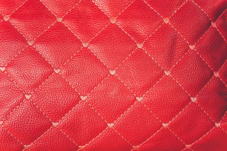 close-up red leather sofa backrest backgroundの写真素材