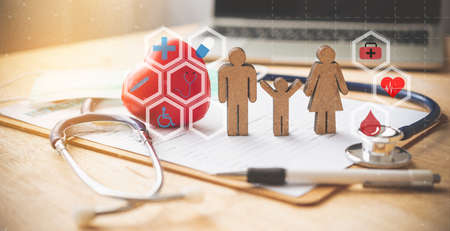 Medical Insurance Concept With Family And Stethoscope On Wooden Desk