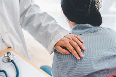 The psychiatrist shook the patient's shoulder. To encourage and comfort the patientの写真素材