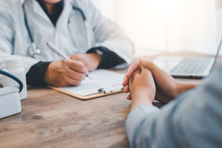 The doctor is discussing with the patient after a physical examination of the results and treatmentの写真素材