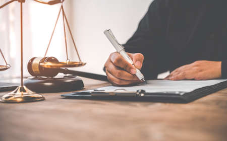 Law theme, mallet of the judge, law enforcement officers, evidence-based cases, and documents taken into account.の写真素材