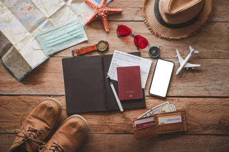Protecting COVID-19 while Traveling. Travel accessories costumes. Passports, luggage, The cost of travel maps prepared for the trip .concept new normal lifestyleの写真素材