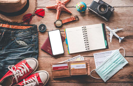 Protection while Traveling. Travel accessories costumes. Passports, luggage, The cost of travel maps prepared for the trip .concept new normal lifestyleの写真素材