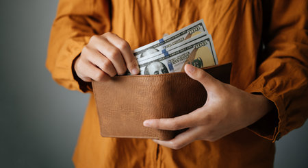 hand takes out a dollar bill from his pocket to spend