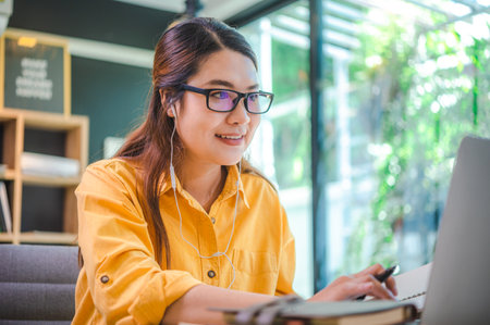 business woman sits working online on a laptop computer in a cafe.