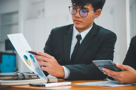 group of business people working and communicating together in the office With the charging of graphs for analysis, conceptual analysis and business planningの写真素材