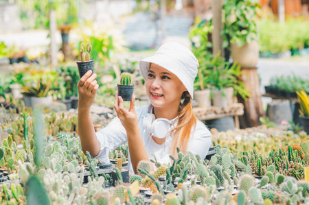 Young women doing hobbies taking care of plants, watering, shoveling flowers. In the garden during the break from workの写真素材