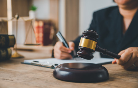 Law theme, mallet of the judge, law enforcement officers, evidence-based cases and documents taken into account.の写真素材