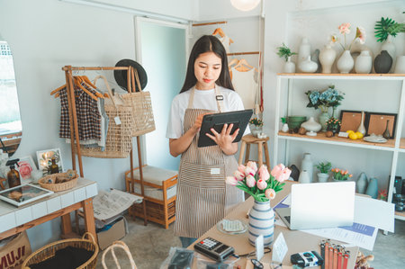 Small business owners are preparing a small shop and checking through a tablet and checking orders.の写真素材