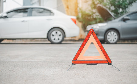 red emergency triangle on the road indicates that there is an accident or car breakdown on the road...