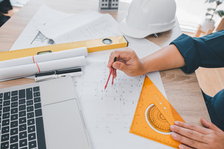engineer working in office with blueprints, inspection in workplace for architectural plan,...