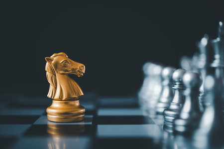 horse golden chess standing confront of the silver chess team.chess board game concept of business ideas and competition and stratagy plan success meaningの写真素材