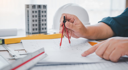 engineer working in office with blueprints, inspection in workplace for architectural plan, construction project ,Business constructionの写真素材