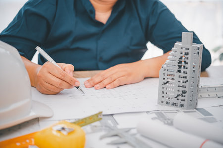 Engineer with collapsed building model, engineer analyzing Cause of building collapse or house...