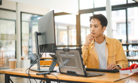 Young programmer working on coding, software development and web design in software company...