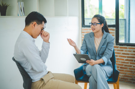 Psychologist listening to the problem of a patient with mental health problems, a patient for treatment encouragement Love and family problems, bipolar, depressed patients prevent suicideの写真素材