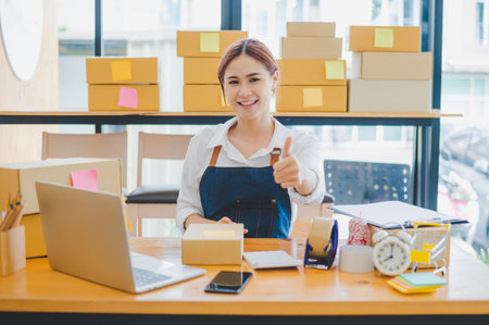 Small business owners online smiling happily at work. where customers place orders and check the orders that the customers have ordered of online retailers - online shoppingの写真素材