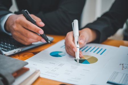 group of business people working and communicating together in the office With the charging of graphs for analysis, conceptual analysis and business planningの写真素材