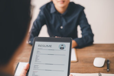 HR managers are interviewing job applicants who fill out their resume on the job application form in order to consider accepting a job as a companyの写真素材