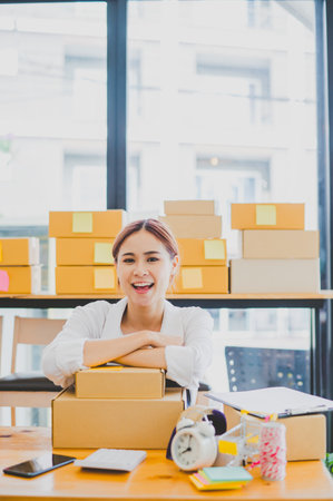 Small business owners online smiling happily at work. where customers place orders and check the orders that the customers have ordered of online retailers - online shoppingの写真素材