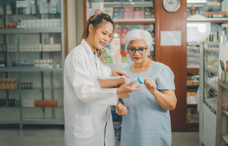 Pharmacist giving advice And advice for patients who come to buy Medicine, Drugs, Vitamins products, according to prescriptions in modern pharmacies.の写真素材
