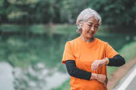 Elderly woman exercising in the park early in the morning.の写真素材