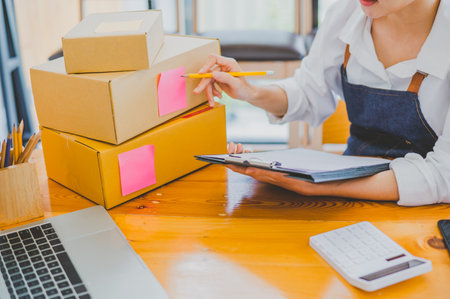 Small business owners online are checking their orders. where customers place orders and check the orders that the customers have ordered of online retailers - online shoppingの写真素材