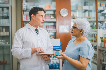 Pharmacist giving advice And advice for patients who come to buy Medicine, Drugs, Vitamins products, according to prescriptions in modern pharmacies.の写真素材