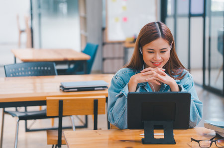 young student wearing small talk studies online, distance learning, and keeps up to date on the global coronavirus pandemicの写真素材