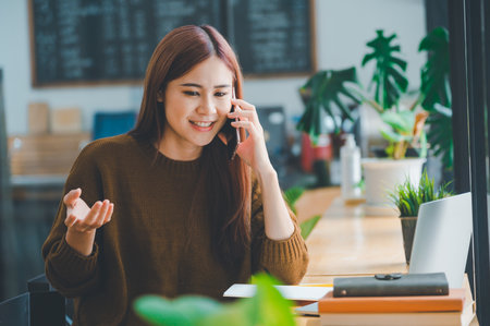 young student wearing headphones studies online, distance learning, and keeps up to date on the global pandemic.の写真素材