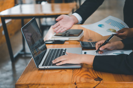 group of business people working and communicating together in the office With the charging of graphs for analysis, conceptual analysis and business planningの写真素材