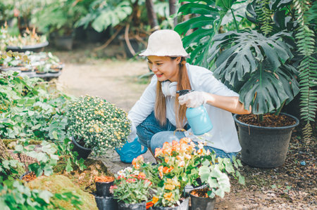 Young women doing hobbies taking care of plants, watering, shoveling flowers. In the garden during the break from workの写真素材