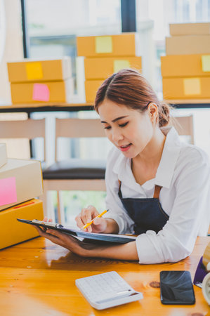 Small business owners online are checking their orders. where customers place orders and check the orders that the customers have ordered of online retailers - online shoppingの写真素材