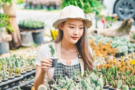Young women doing hobbies taking care of plants, watering, shoveling flowers. In the garden during the break from workの写真素材