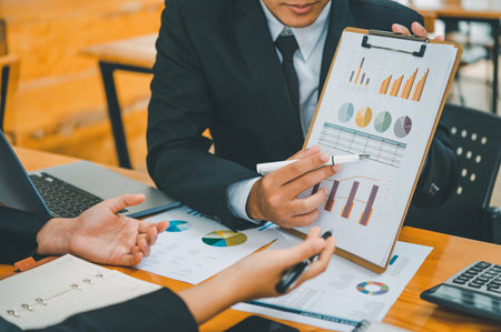group of business people working and communicating together in the office With the charging of graphs for analysis, conceptual analysis and business planningの写真素材
