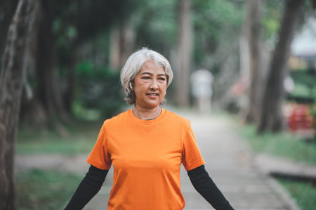 Elderly woman exercising in the park early in the morning.の写真素材