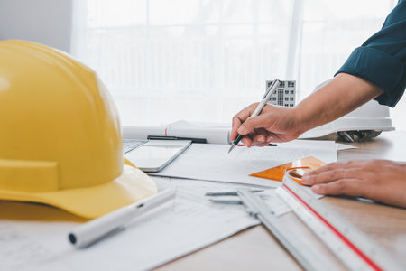 engineer working in office with blueprints, inspection in workplace for architectural plan, construction project ,Business constructionの写真素材