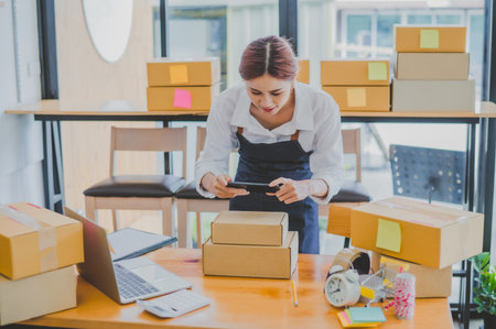 Small business owners online are taking pictures of their products and offering them to customers who will place their orders. and check the orders that the customers have ordered of online retailers - online shoppingの写真素材