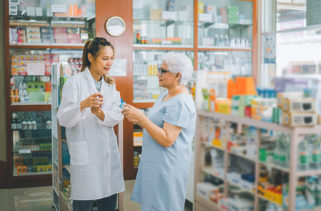 Pharmacist giving advice And advice for patients who come to buy Medicine, Drugs, Vitamins products, according to prescriptions in modern pharmacies.の写真素材