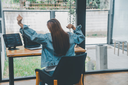 Female programmers are stretching oneself and relaxing after working and planning to work on programming, software coding and web design. Concept technology development.の写真素材