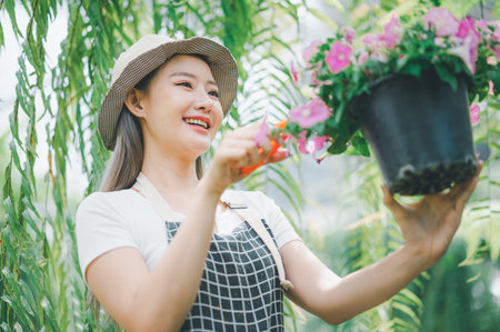 Young women doing hobbies taking care of plants, watering, shoveling flowers. In the garden during the break from workの写真素材