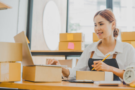 Small business owners online are writing their names and addresses to deliver products and products to their customers. and check the orders that the customers have ordered of online retailers - online shoppingの写真素材