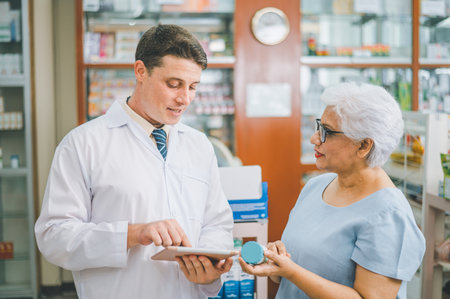 Pharmacist giving advice And advice for patients who come to buy Medicine, Drugs, Vitamins products, according to prescriptions in modern pharmacies.の写真素材