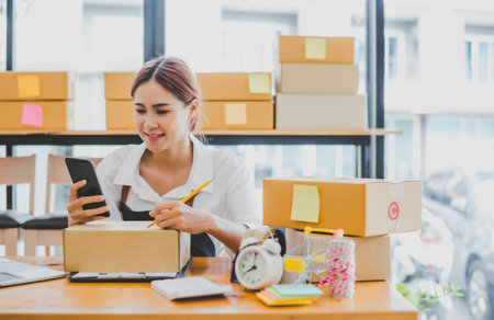 Small business owners online are writing their names and addresses to deliver products and products to their customers. and check the orders that the customers have ordered of online retailers - online shoppingの写真素材