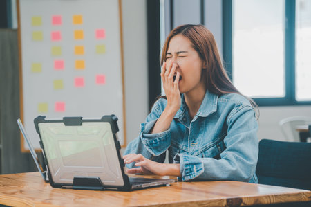 Female programmers are sleepy and exhausted after working and planning to work on programming, software coding and web design. Concept technology development.の写真素材