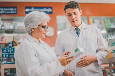 skilled pharmacist is consulting, analyzing the use of drugs to recommend and supervise patients according to prescriptions in modern pharmacies.の写真素材